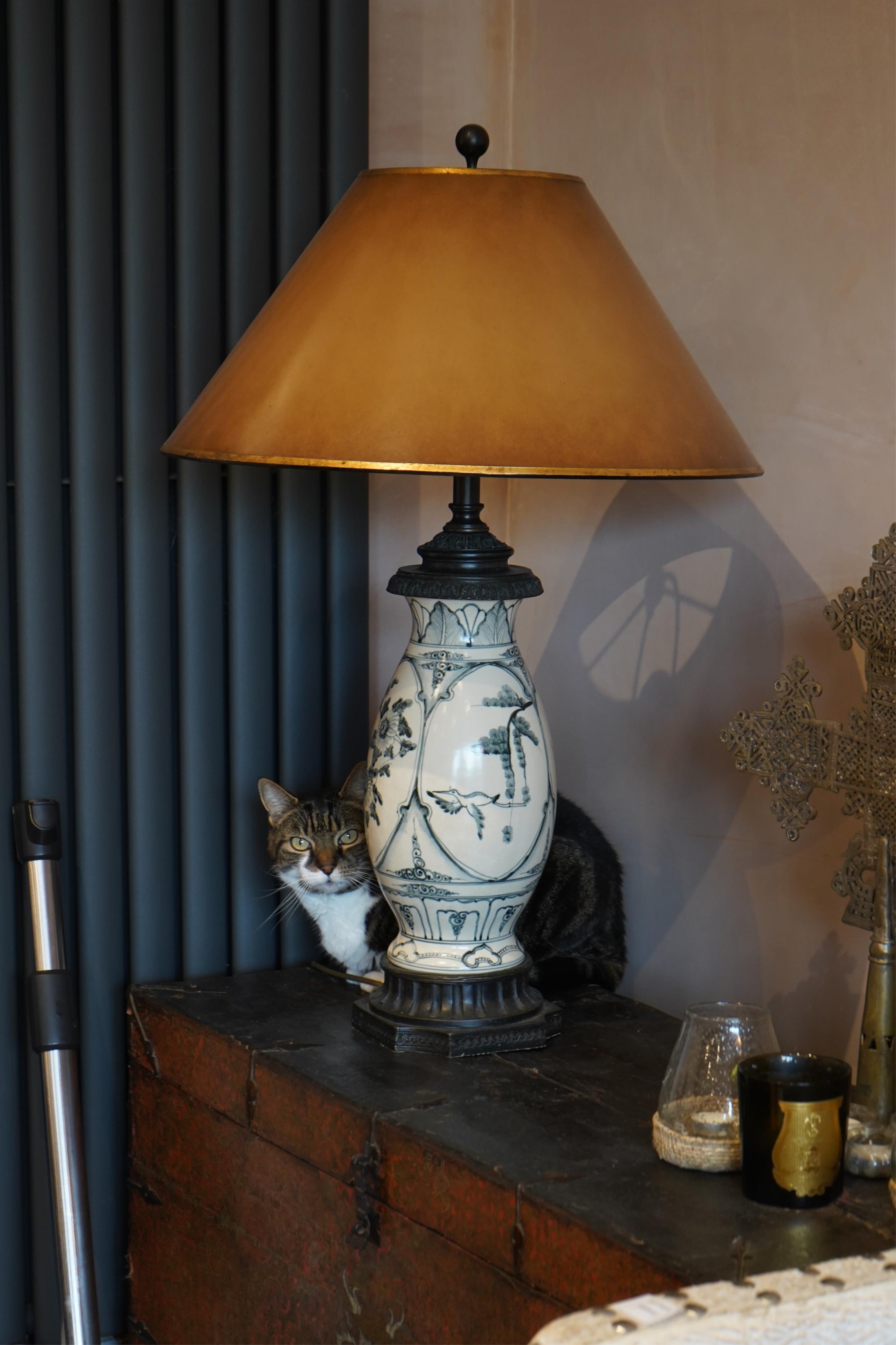 A pair of blue and white ceramic lamps with shades, originally brought from Harrods, overall 90cm high. Condition - good, untested